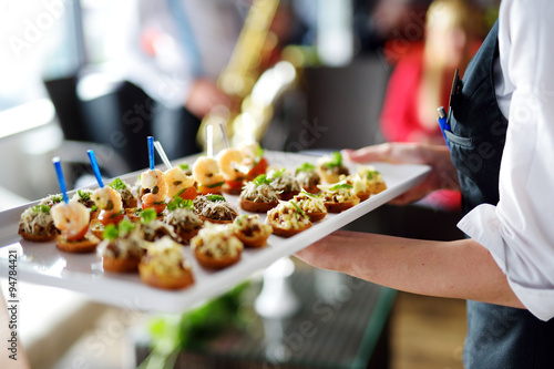 Waiter carrying plates with meat dish