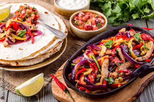 Pork fajitas with onions and colored pepper, served with tortill