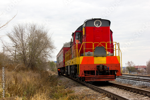red-yellow locomotive train on the tracks