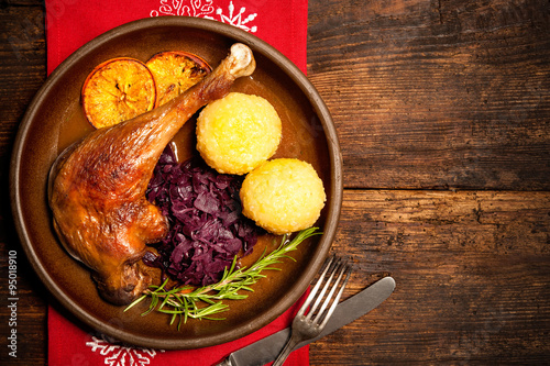 Crusty goose leg with braised red cabbage and dumplings