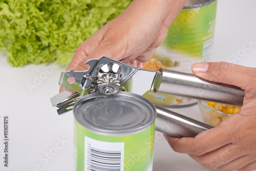 woman hands using a can opener