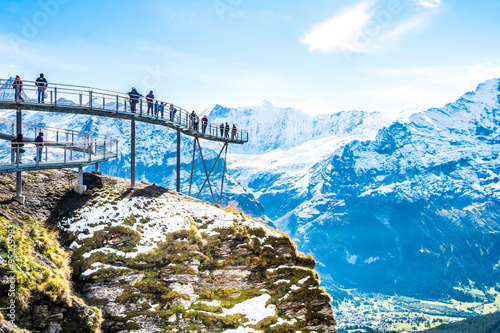 Steel catwalk over snowy Alps round the First top station above Grindelwald, Switzerland.