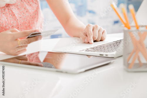 Woman Hands holding credit card and using laptop. Online shoppin