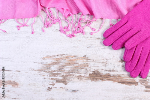Woolen gloves and shawl with copy space for text, old rustic wooden background