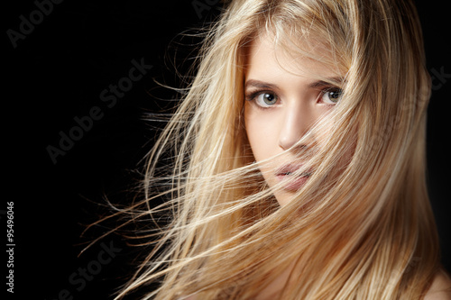 Portrait of beautiful blonde woman with flying hair.