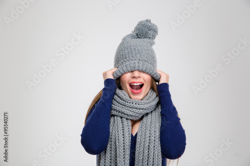 Woman covering her eyes with hat