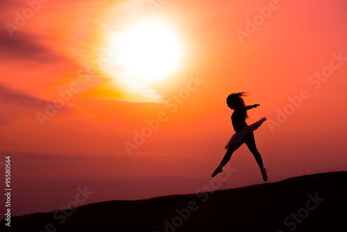 Ballerina in silhouette in a red sunset