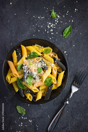 colorful penne pasta with parmesan cheese and basil