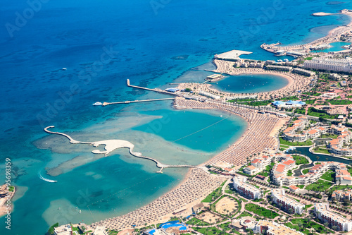 Sea bays with piers and locations enclosures for swimming and tanning, Egyptian resorts, aerial view, the Red Sea, Egypt