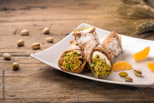 Sicilian cannoli stuffed with ricotta cheese and pistachio, traditional Sicilian dessert, Italian pastry