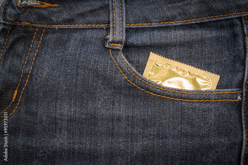 Condom in jeans pocket. background.