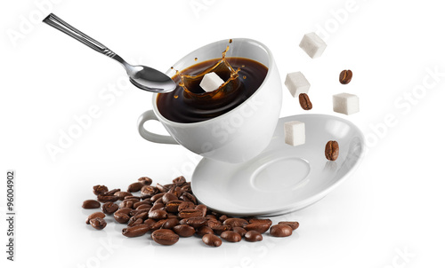 Cup of coffee with coffee beans and sugar on a white background.