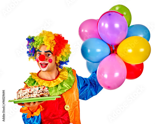 Happy birthday clown holding a bunch of balloons. 
