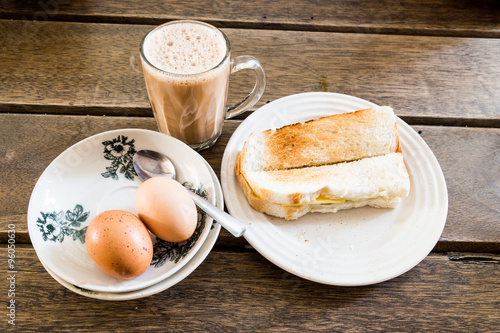 Popular Malaysian breakfast teh tarik, toast bread and half-boiled egg