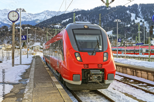 Shiny red train stopped at the Germany, Garmisch-Partenkirchen railway station
