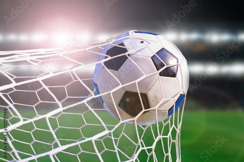 soccer ball hit the net,success goal concept on stadium light ba