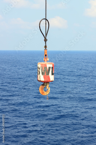 hook crane at offshore and sea,blue sky background.
