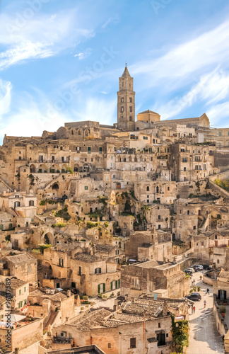 panoramic view of typical stones (Sassi di Matera) and church of Matera UNESCO European Capital of Culture 2019 under blue sky