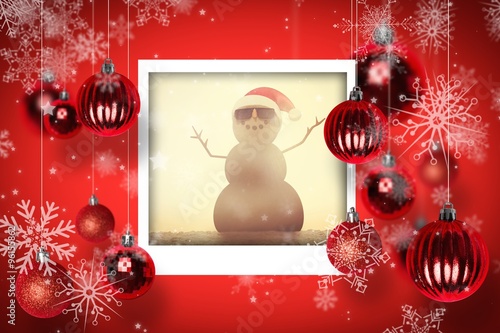 Composite image of festive sandman on the beach