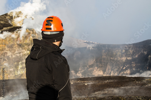 geologist looks at the craters of the erupting volcano Etna