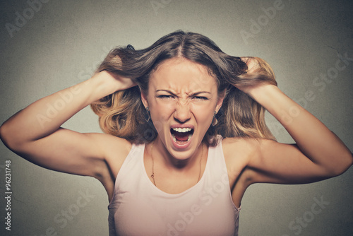 frustrated angry woman pulling hair out yelling screaming