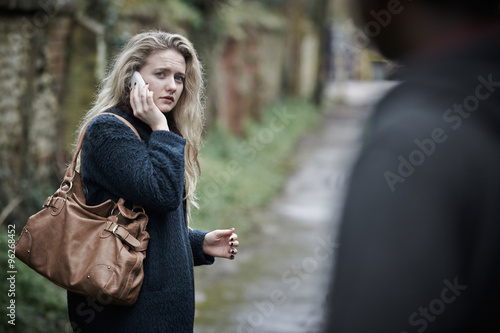 Teenage Girl Feeling Threatened As She Walks Along Path