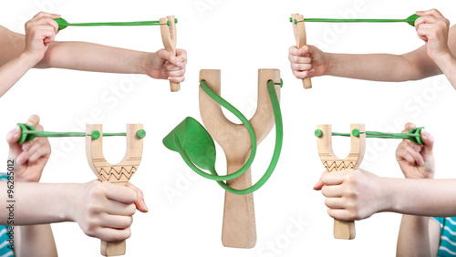 set of female hands with wooden slingshot