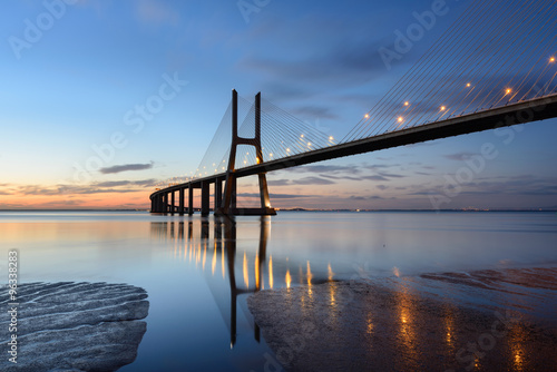 Ponte Vasco da Gama ao anoitecer com iluminação.