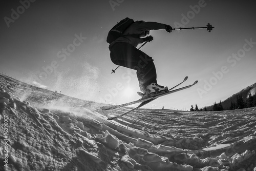black and white shot of free skier jumping
