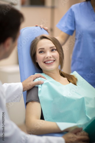 Dentist comforting patient