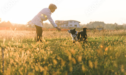 Middle age woman playing with her border collie dog