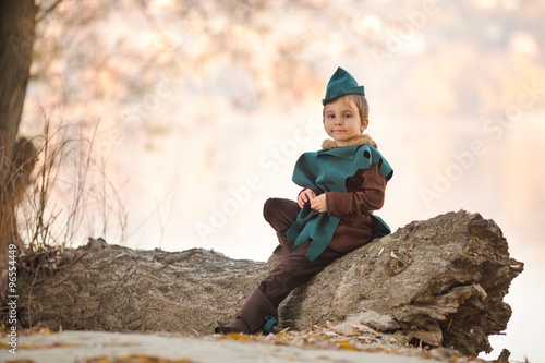 Cute little boy dressed as a knight playing outdoors