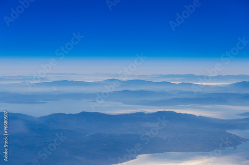 Deep blue sky above landscape with mountains and sea,atmospheric aerial photography