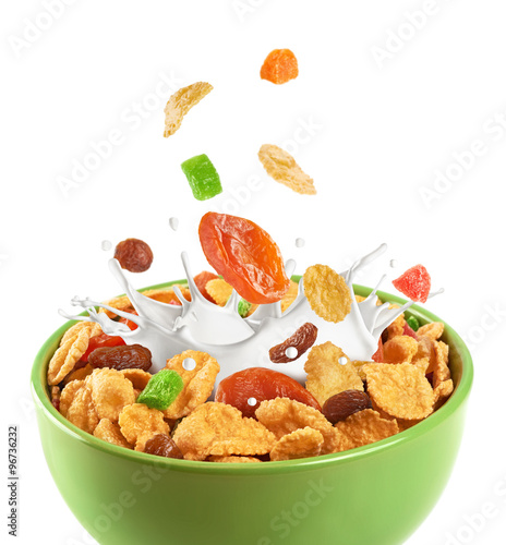 Bowl of muesli and dried fruit isolated on a white background.
