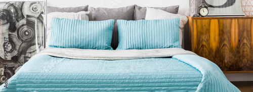 Turquoise cushions and bedspread