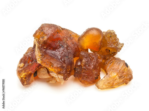 Macro closeup of Organic Indian bdellium or Guggul resin (Commiphora wightii) isolated on white background.