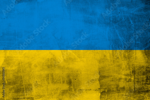 Grunge flag of Ukraine on concrete wall