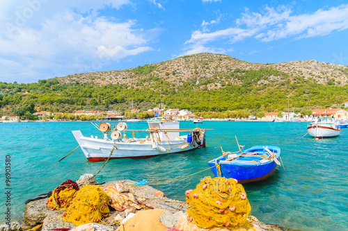 Colorful Greek fishing boats with nets on shore in Posidonio bay, Samos island, Greece
