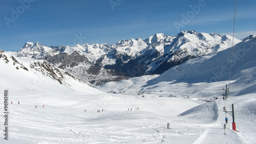 skiers on the ski resort of Formigal in Aragon - Spain, snowy mountain landscape, nature and sport background