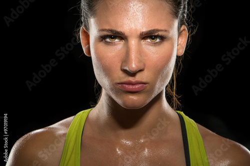 Intense stare eyes determined athlete champion glare head shot sweaty confident woman female powerful fighter close up