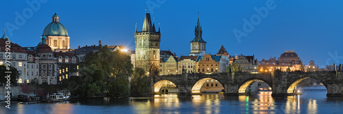 Prague, Czech Republic. Evening panorama of the Charles Bridge with dome of the Saint Francis of Assisi Church, Old Town Bridge Tower, Old Town Water Tower, dome of the National Theatre.