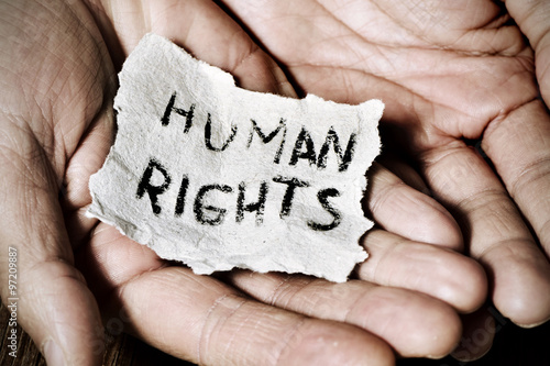 young man with a paper with the text human rights