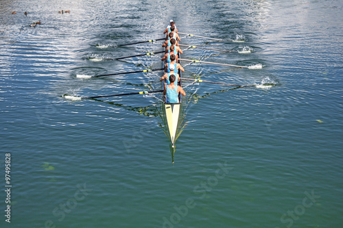 Boat coxed eight Rowers training rowing on the lake