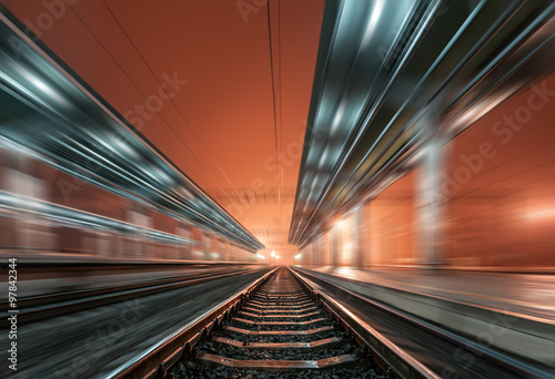 Railway station at night with motion blur effect. Railroad