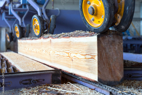 Sawmill. The process of cutting logs into boards. Automatic line sawing. Soft focus