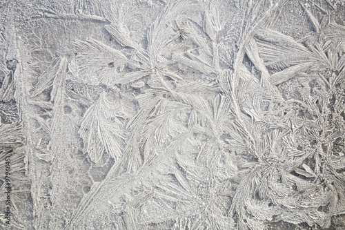 Ice patterns on winter glass . Frozen flowers. Frozen fern. White color. Macro lens.