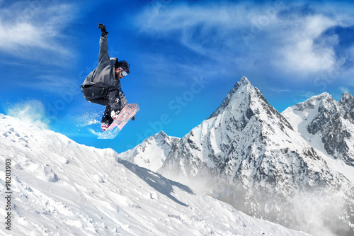 Extreme snowboarding man / Snowboarder jumping high in the air