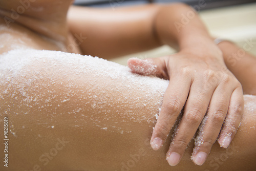 young woman scrub treatment on the skin with salt scrub