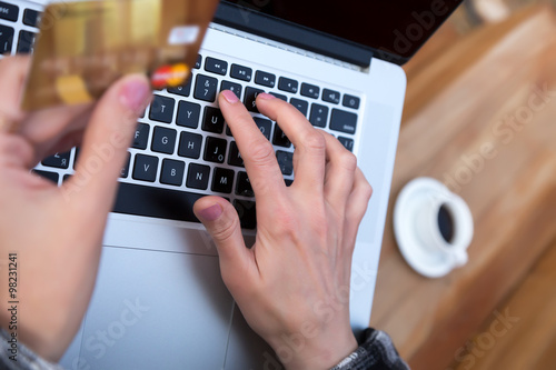 Hands of person entering credit Card Data on Laptop