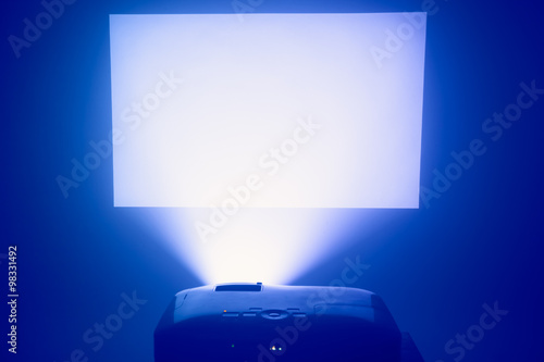 projector in action with illuminated screen